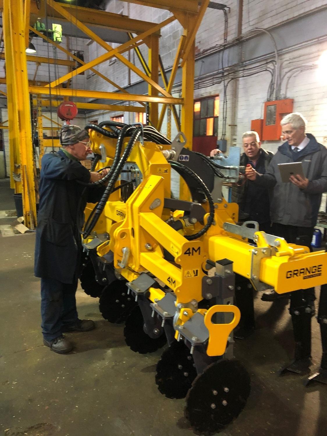 Polydon Industries engineers at work on yellow machinery